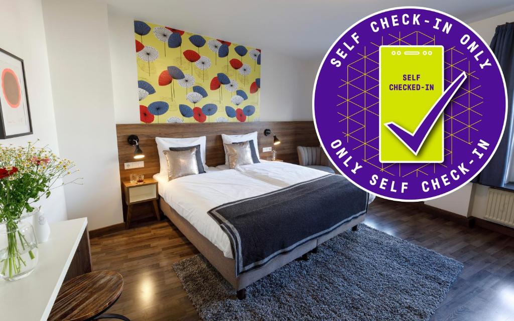 a bedroom with a bed and a purple sign at KONCEPT HOTEL Zum Kostbaren Blut in Cologne