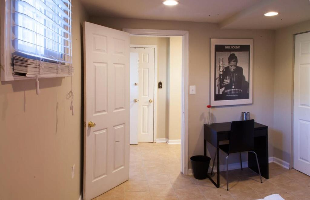 a hallway with a door and a desk in a room at 1BR Oasis near Takoma Metro Minutes to Capital in Washington, D.C.
