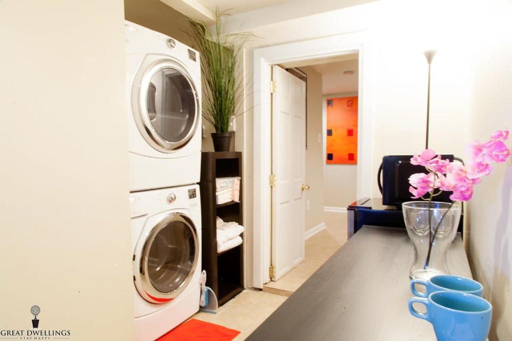 a laundry room with a washer and dryer at 1BR Oasis near Takoma Metro Minutes to Capital in Washington, D.C.