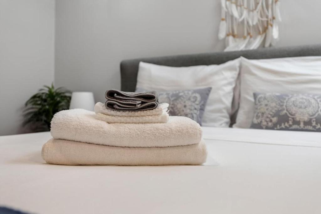 a pile of towels sitting on top of a bed at Entire 1-BR Apt in NoMa Eckington in Washington, D.C.