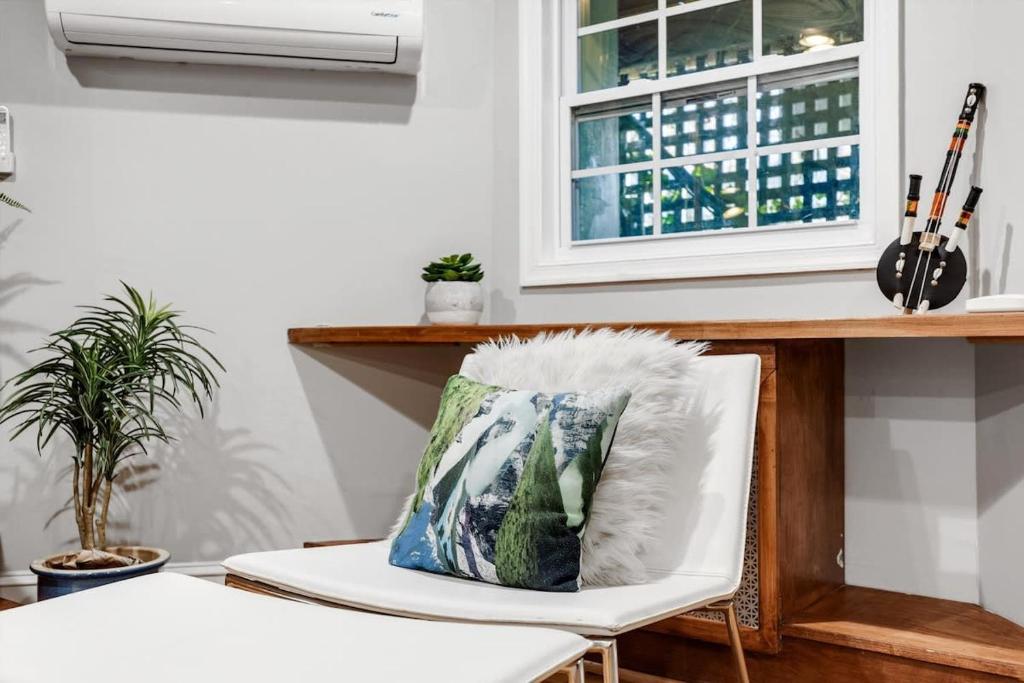 a pillow sitting on a chair in a room with a window at Entire 1-BR Apt in NoMa Eckington in Washington, D.C.