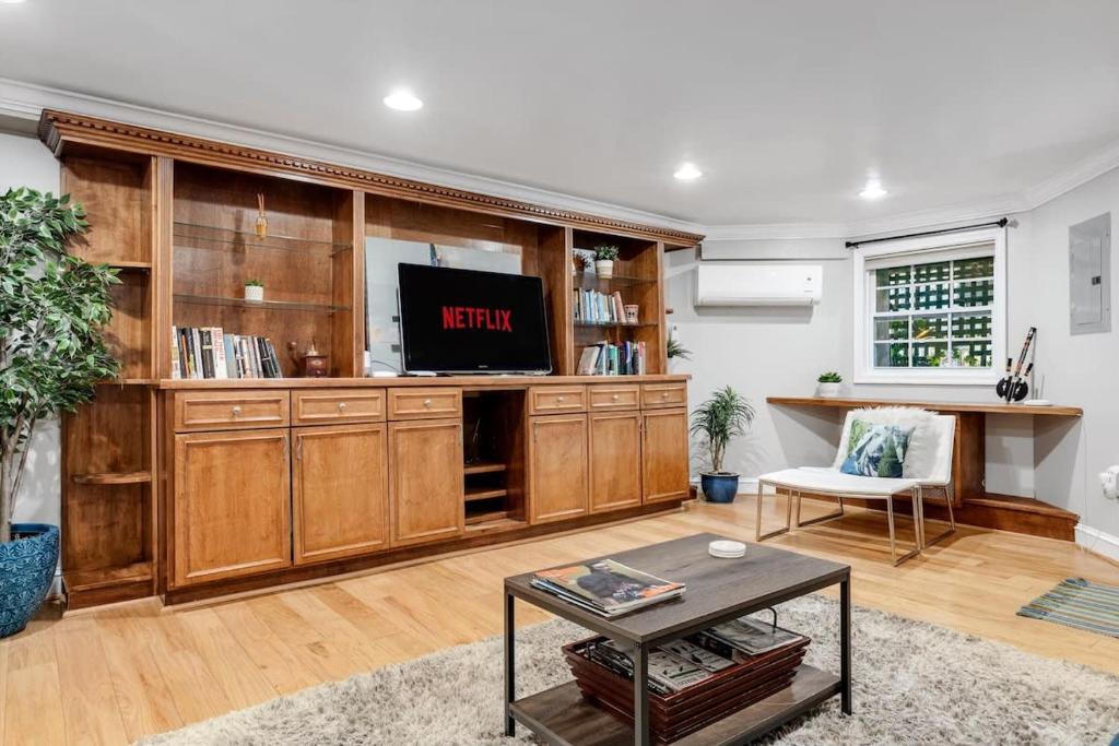 a living room with a large wooden entertainment center at Entire 1-BR Apt in NoMa Eckington in Washington, D.C.