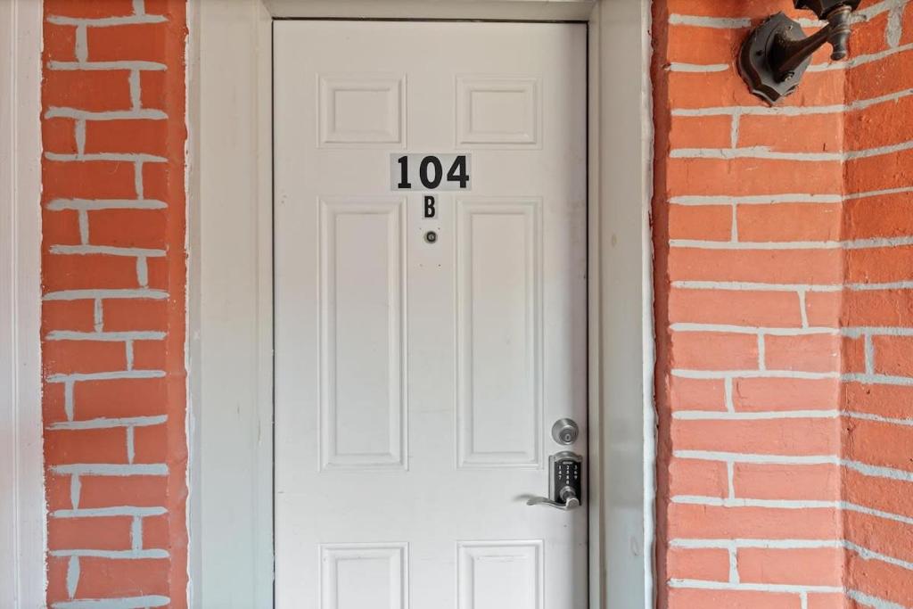 a white door with the number on it at Entire 1-BR Apt in NoMa Eckington in Washington, D.C.