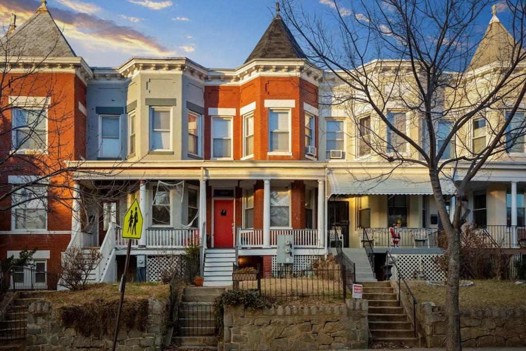 a large house with a red door on a street at Entire 1-BR Apt in NoMa Eckington in Washington, D.C.