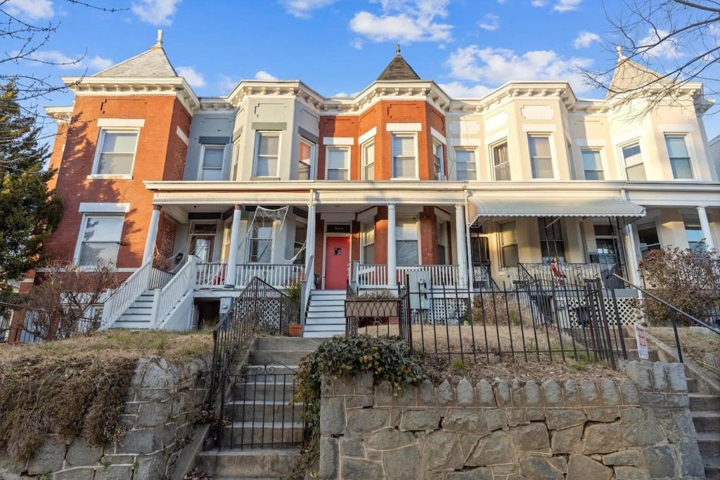 a large house with a red door on a street at Entire 1-BR Apt in NoMa Eckington in Washington, D.C.