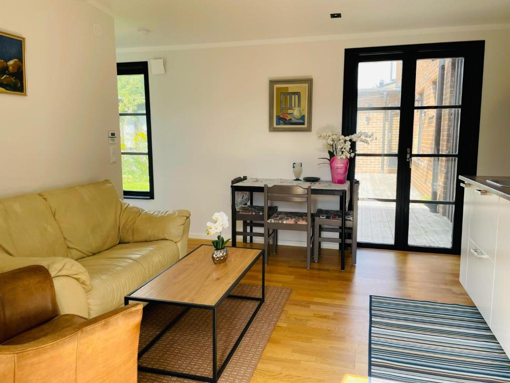 a living room with a couch and a table at 3-Bedroom Charming Lund Home in Lund
