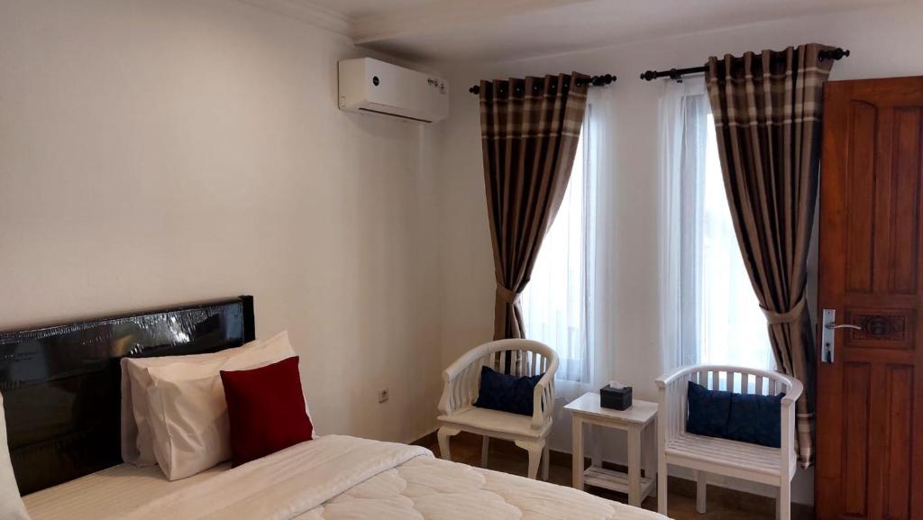 Postel nebo postele na pokoji v ubytování Grand Melka Hotel