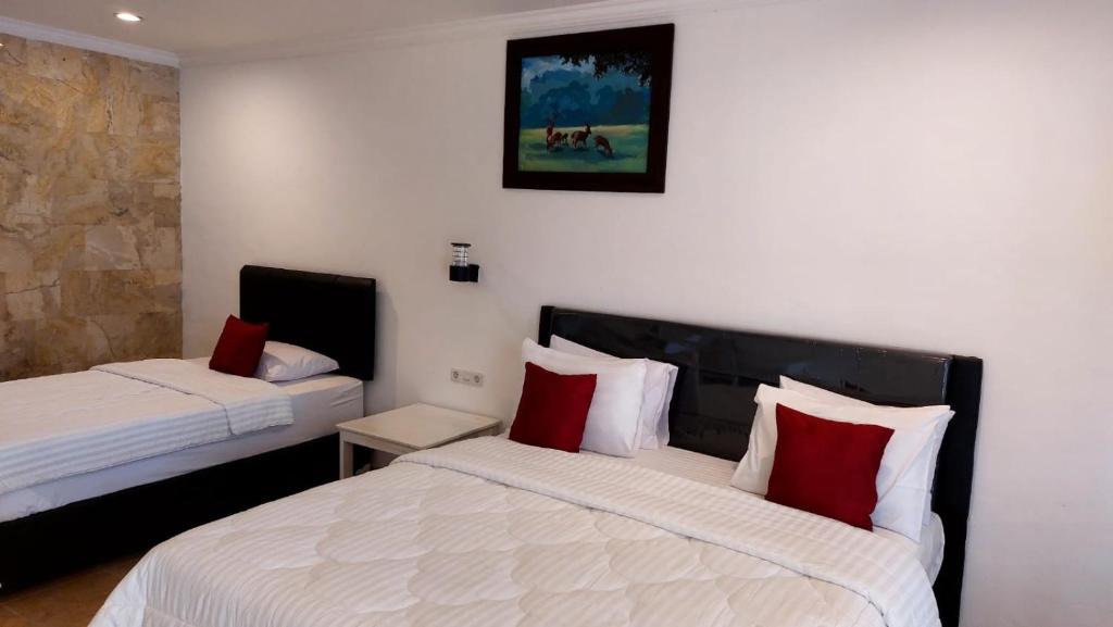 Postel nebo postele na pokoji v ubytování Grand Melka Hotel
