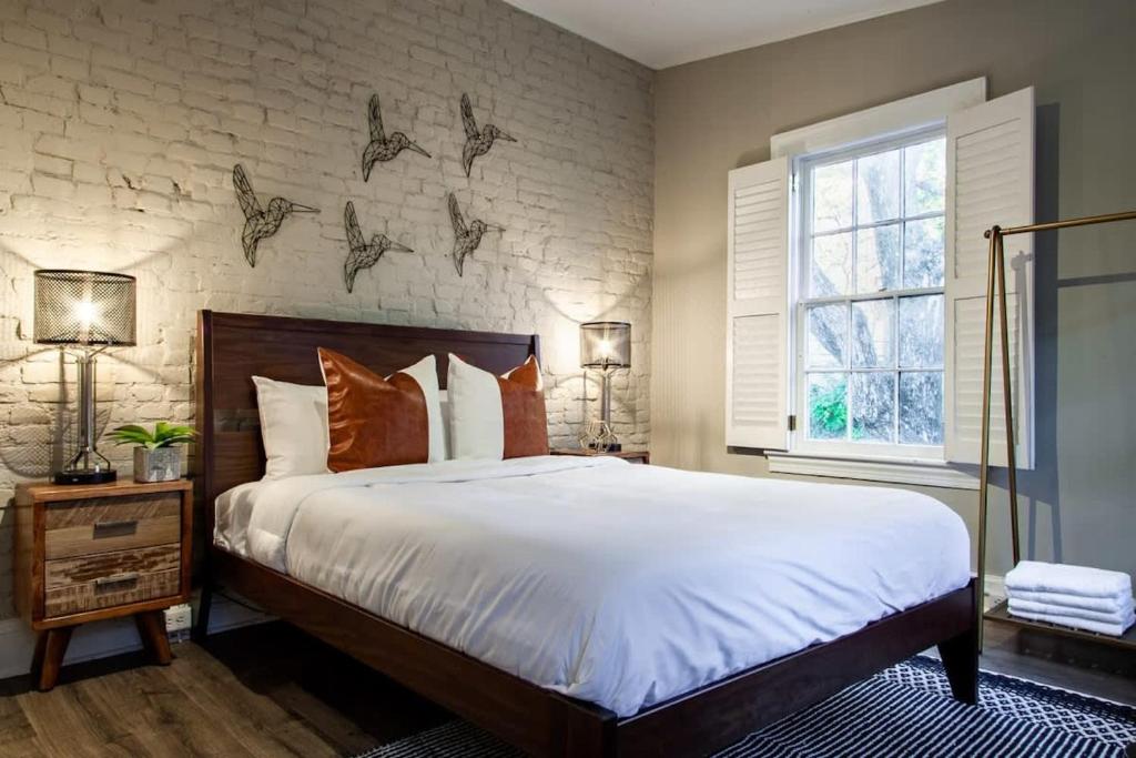 a bedroom with a large bed and a brick wall at IDEAL GEORGETOWN STAY \ PARKING! \ W/D in Washington, D.C.