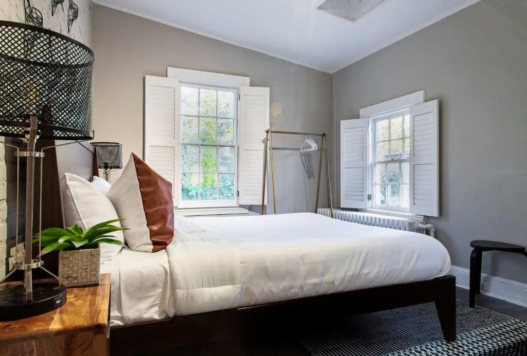 a bedroom with a white bed and two windows at IDEAL GEORGETOWN STAY \ PARKING! \ W/D in Washington, D.C.