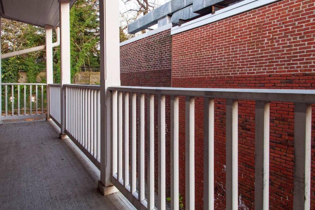a balcony with a brick wall and a metal railing at IDEAL GEORGETOWN STAY \ PARKING! \ W/D in Washington, D.C.