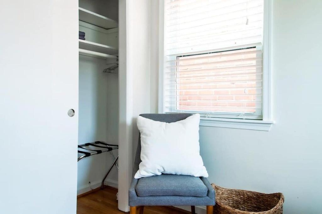 a bedroom with a blue chair and a window at Transit-Friendly Home Old Town Parking in Alexandria