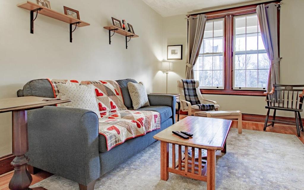 a living room with a blue couch and a table at The E St Retreat Lovely 3-BR Nestled between H St & Eastern Market in Washington, D.C.