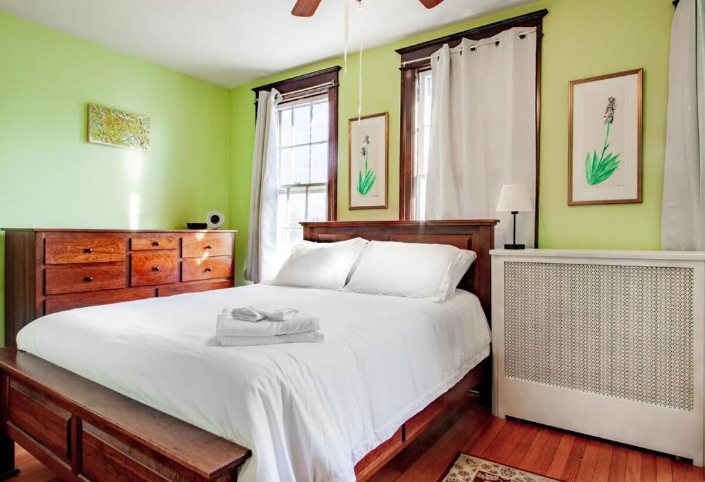 a bedroom with a large white bed and a window at The E St Retreat Lovely 3-BR Nestled between H St & Eastern Market in Washington, D.C.