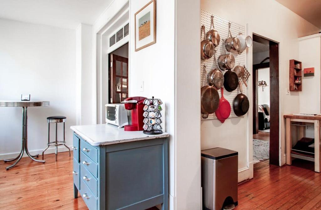 a kitchen with a counter with a microwave and pans at The E St Retreat Lovely 3-BR Nestled between H St & Eastern Market in Washington, D.C.