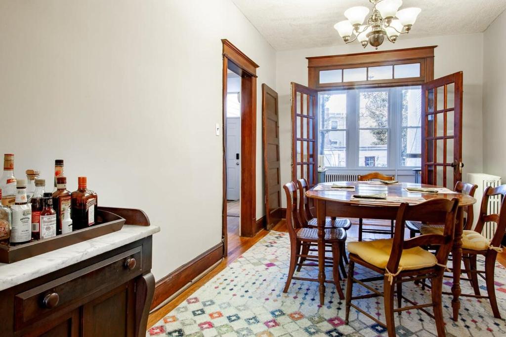 a kitchen with a table and chairs and a dining room at The E St Retreat Lovely 3-BR Nestled between H St & Eastern Market in Washington, D.C.