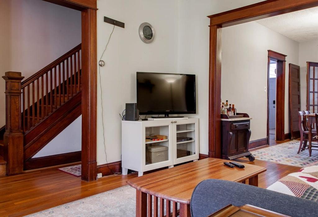 a living room with a tv on a white cabinet at The E St Retreat Lovely 3-BR Nestled between H St & Eastern Market in Washington, D.C.