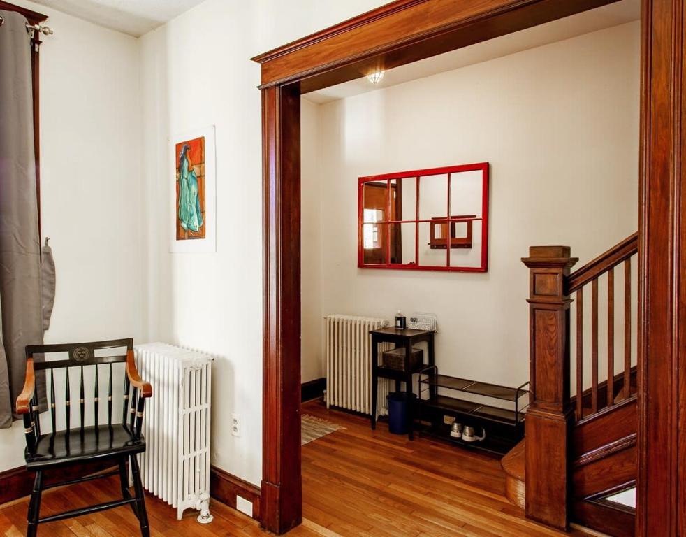 a living room with a staircase and a mirror at The E St Retreat Lovely 3-BR Nestled between H St & Eastern Market in Washington, D.C.