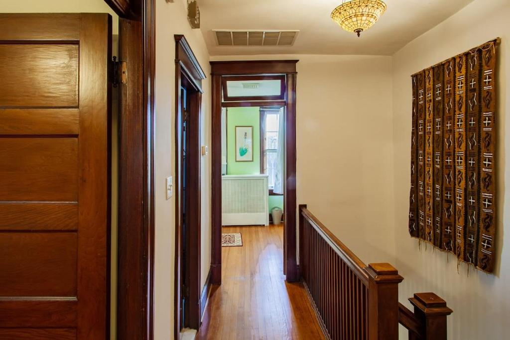 a hallway of a home with a door and a staircase at The E St Retreat Lovely 3-BR Nestled between H St & Eastern Market in Washington, D.C.