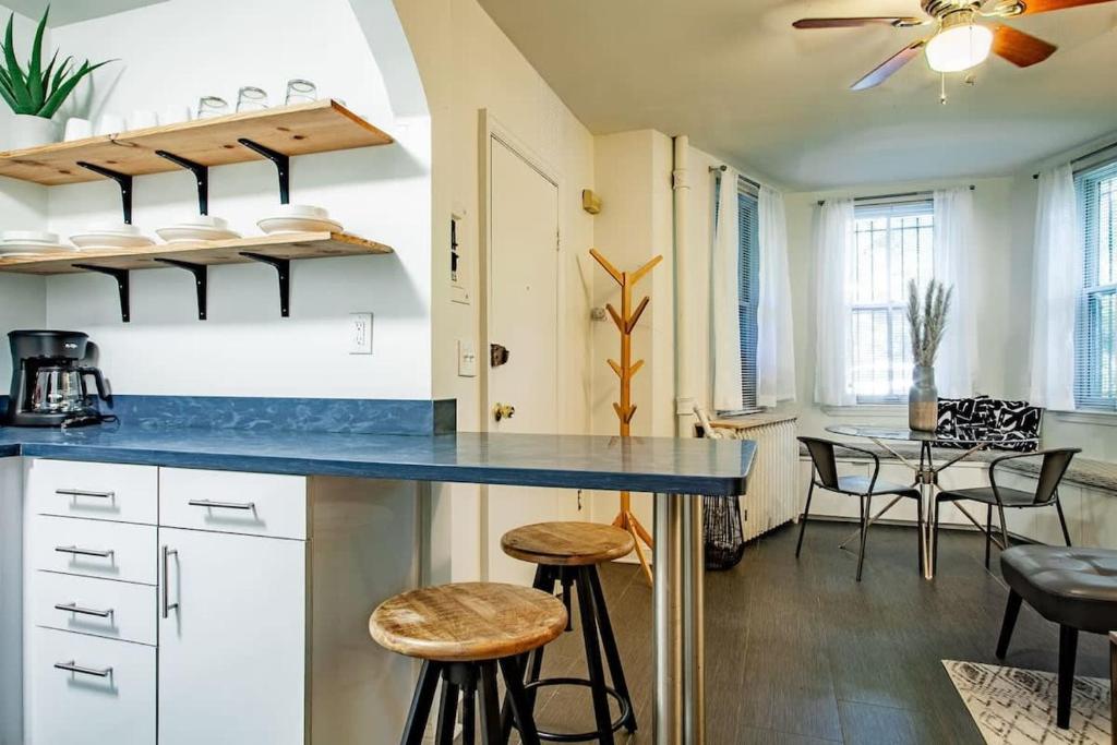 a kitchen with a blue counter and stools at DesignerFlat Nestled Between Dupont&Logan Circles in Washington, D.C.