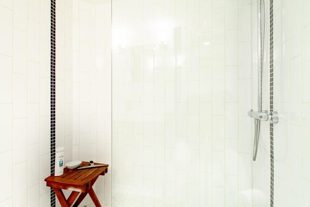 a shower with a wooden table in a bathroom at The E St Retreat Lovely 3-BR Nestled between H St & Eastern Market in Washington, D.C.