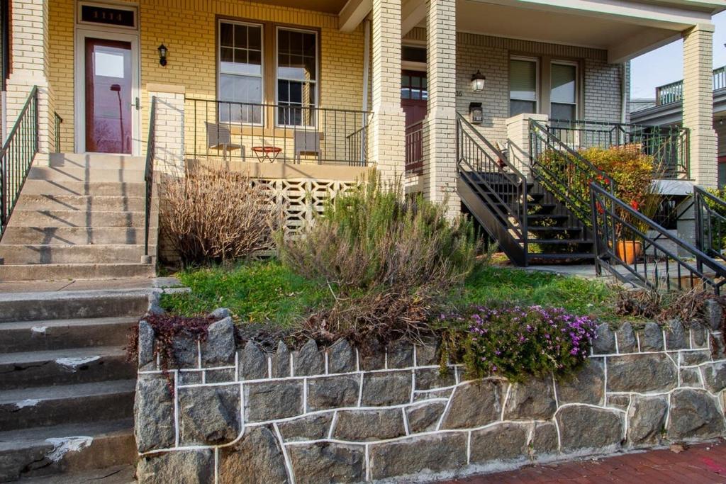 a house with a stone retaining wall and stairs at The E St Retreat Lovely 3-BR Nestled between H St & Eastern Market in Washington, D.C.