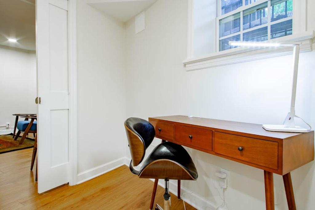 a desk with a chair next to a window at A Classy Corner of DC Minutes walk to Dupont Circle in Washington, D.C.