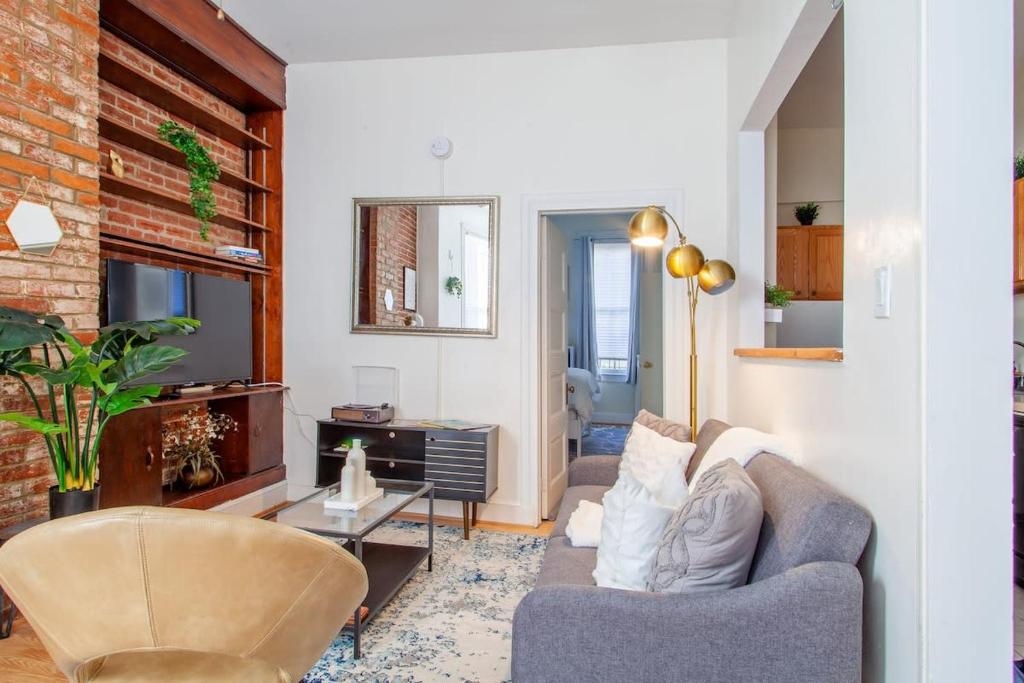 a living room with a couch and a chair at Classy 1-BR Flat Nestled Between Dupont & Logan in Washington, D.C.