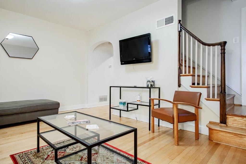 a living room with a glass table and a couch at Pentagon City Homestay Parking available in Arlington