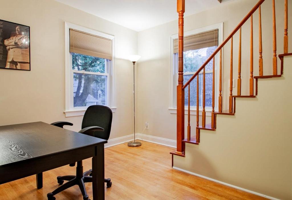 a home office with a desk and a staircase at Pentagon City Homestay Parking available in Arlington