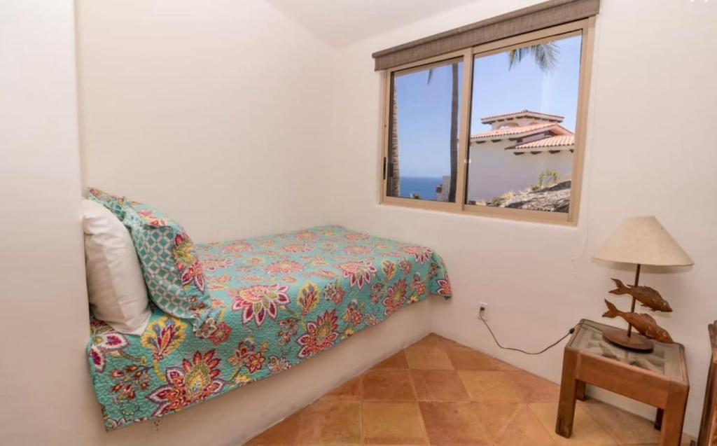 a bedroom with a bed and a window at Infinite views of Palmilla beach and East Cape in San José del Cabo