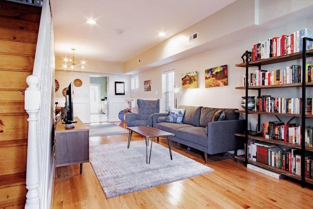 a living room with a couch and book shelves at Family-friendly Home for travelers Near subway in Washington, D.C.