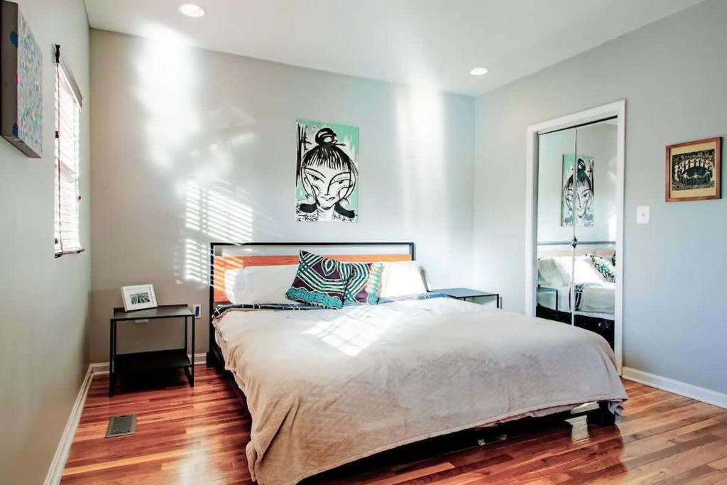 a bedroom with a large bed and a mirror at Family-friendly Home for travelers Near subway in Washington, D.C.