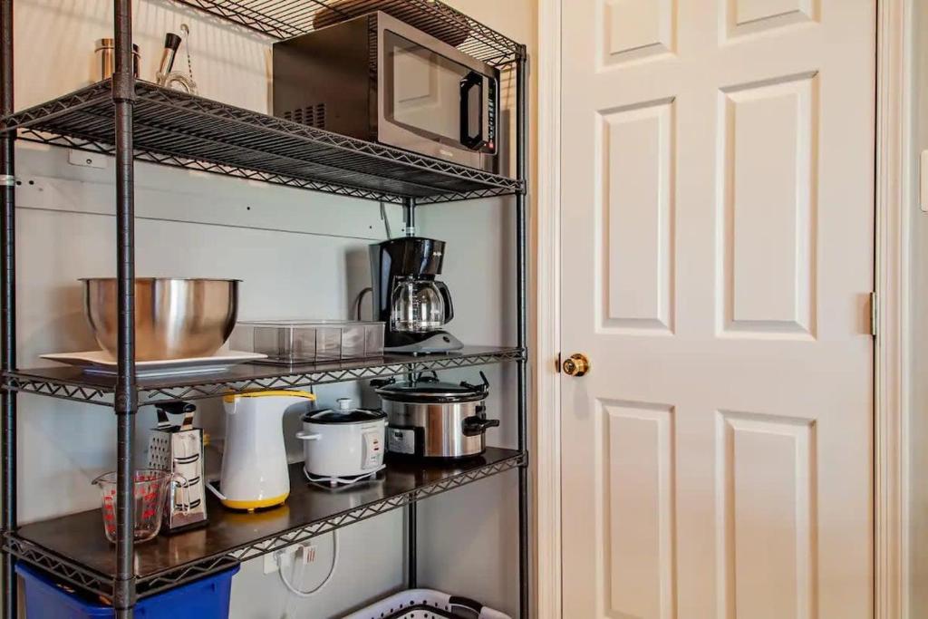 a kitchen with a shelf with pots and pans at Family-friendly Home for travelers Near subway in Washington, D.C.
