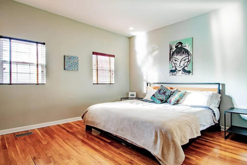a bedroom with a large bed and a wooden floor at Family-friendly Home for travelers Near subway in Washington, D.C.