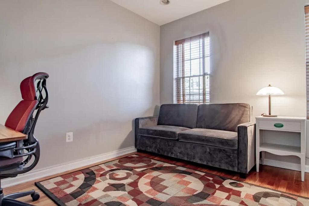 a living room with a couch and a chair at Family-friendly Home for travelers Near subway in Washington, D.C.