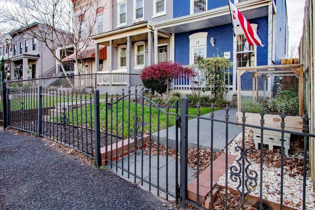 a fence in front of a blue house at Family-friendly Home for travelers Near subway in Washington, D.C.