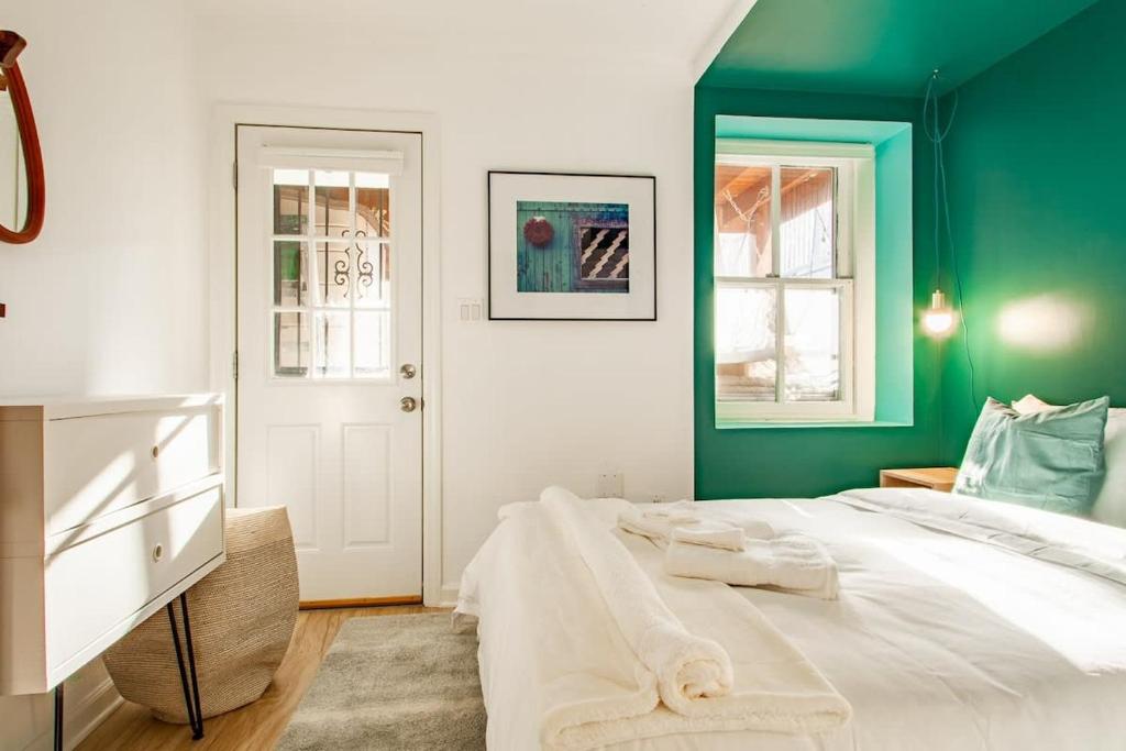 a green and white bedroom with a large bed at Over the Moon About C Adams Morgan METRO subway Rock Creek Park in Washington, D.C.