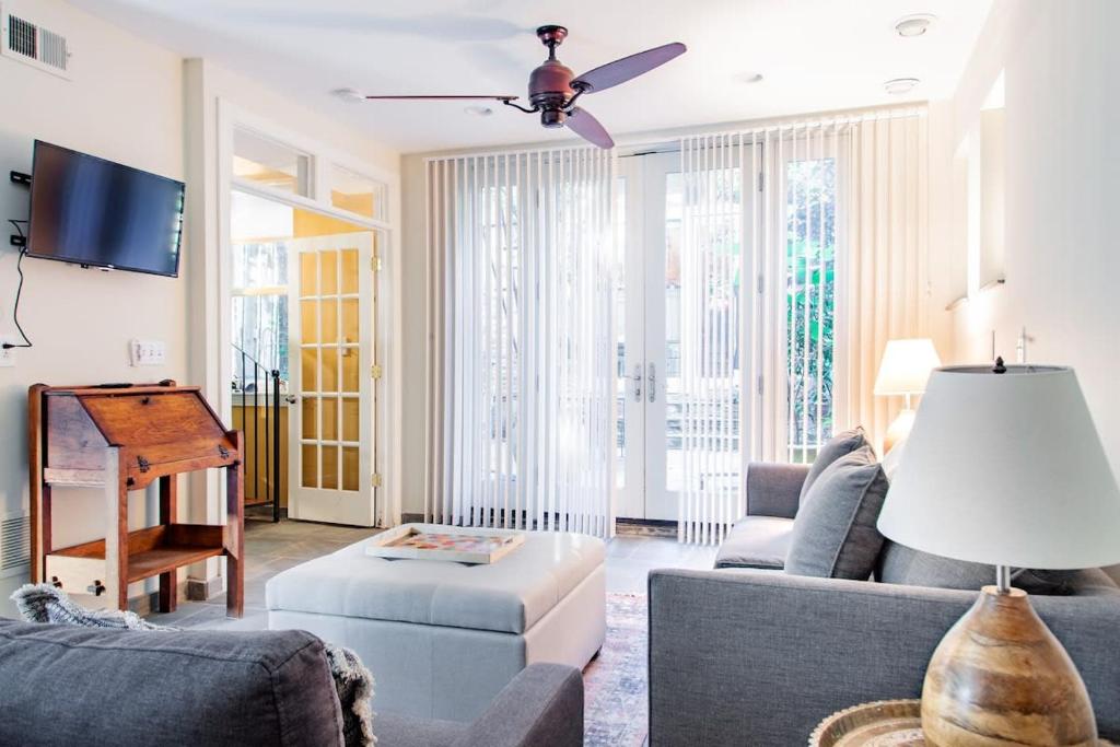 a living room with a couch and a piano at H St Sanctuary Capitol Hill Carriage House in Washington, D.C.