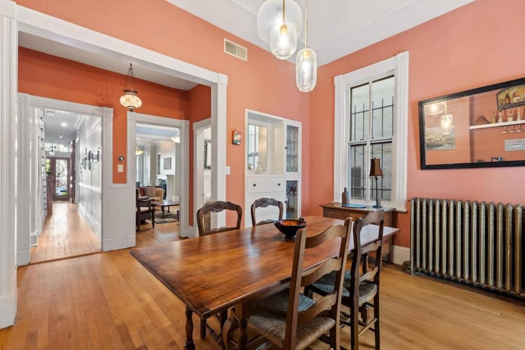 a dining room with a wooden table and chairs at Capitol Hill Homestay Convenient to H St in Washington, D.C.