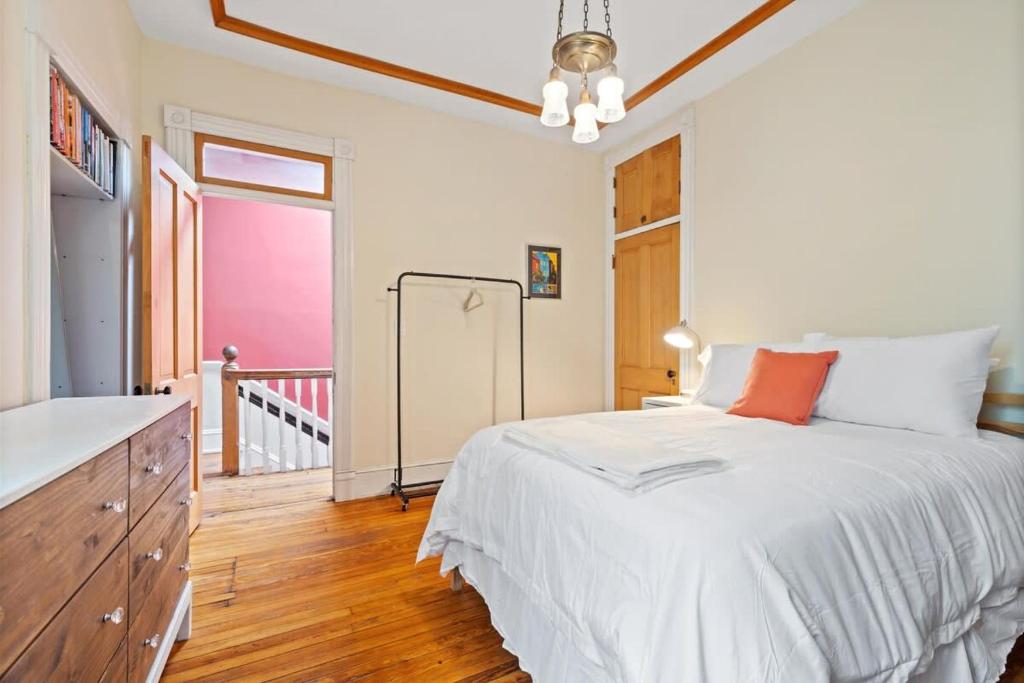 a bedroom with a large white bed and a window at Capitol Hill Homestay Convenient to H St in Washington, D.C.