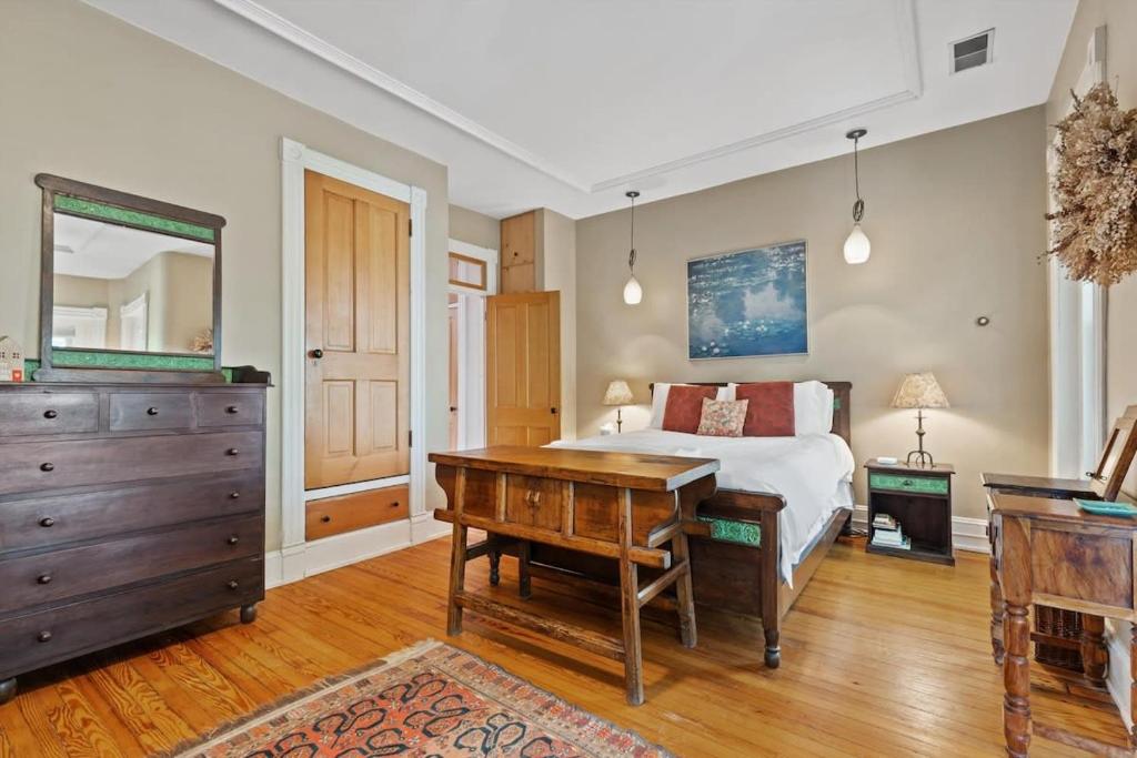 a bedroom with a bed and a desk and a dresser at Capitol Hill Homestay Convenient to H St in Washington, D.C.