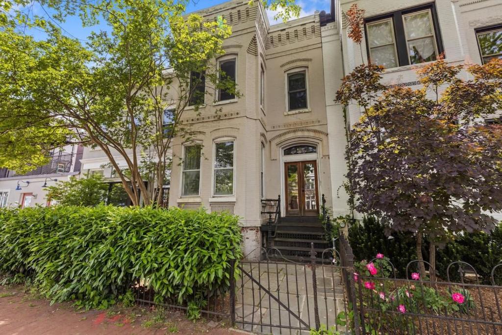 a white house with a gate in front of it at Capitol Hill Homestay Convenient to H St in Washington, D.C.