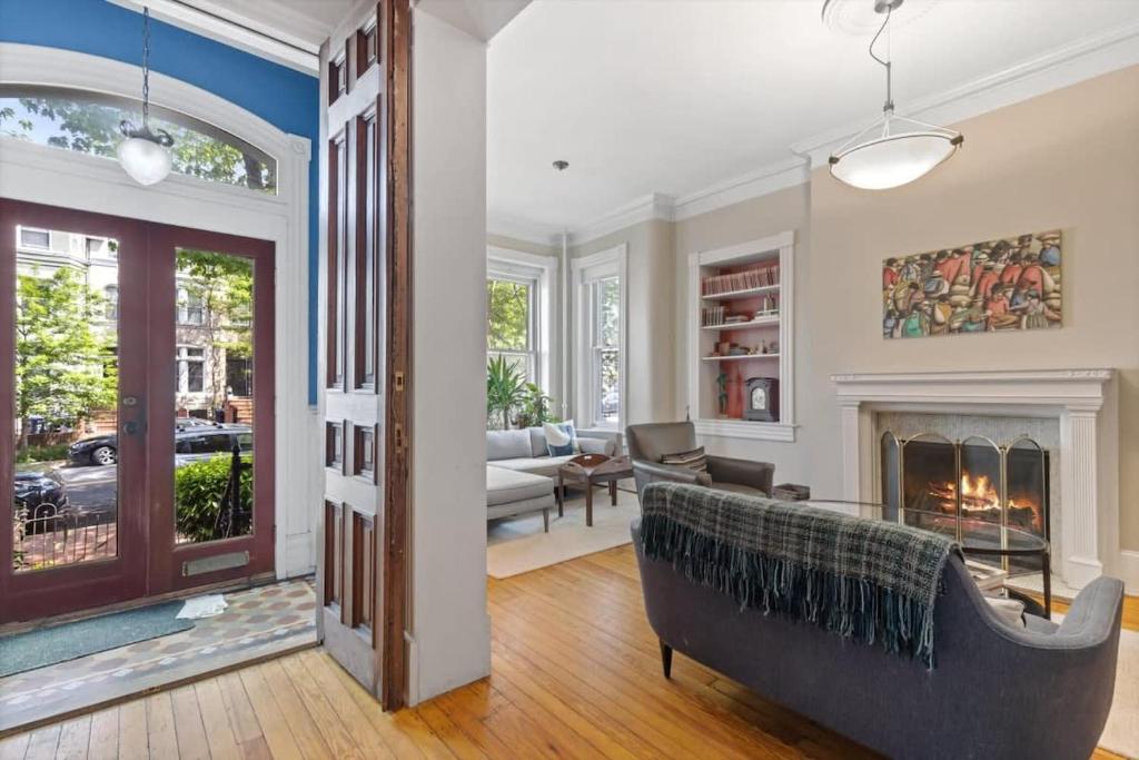 a living room with a couch and a fireplace at Historic Capital Hill Home and Carriage House in Washington, D.C.