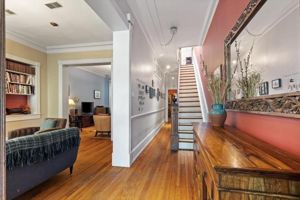 a living room with a couch and a staircase at Historic Capital Hill Home and Carriage House in Washington, D.C.