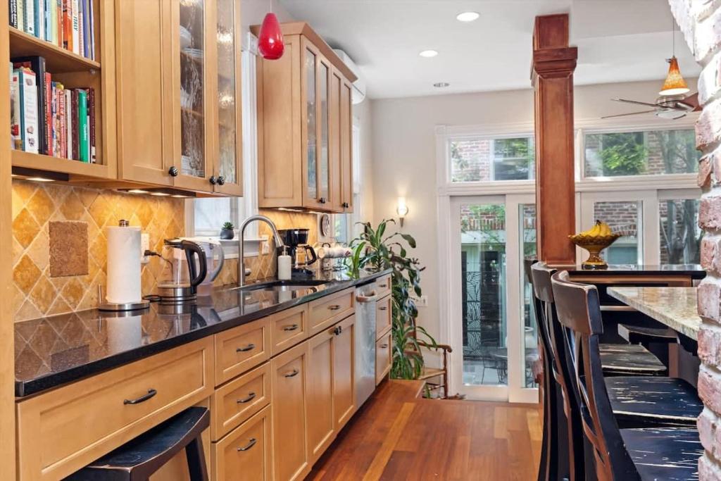 a kitchen with wooden cabinets and a counter top at Historic Capital Hill Home and Carriage House in Washington, D.C.