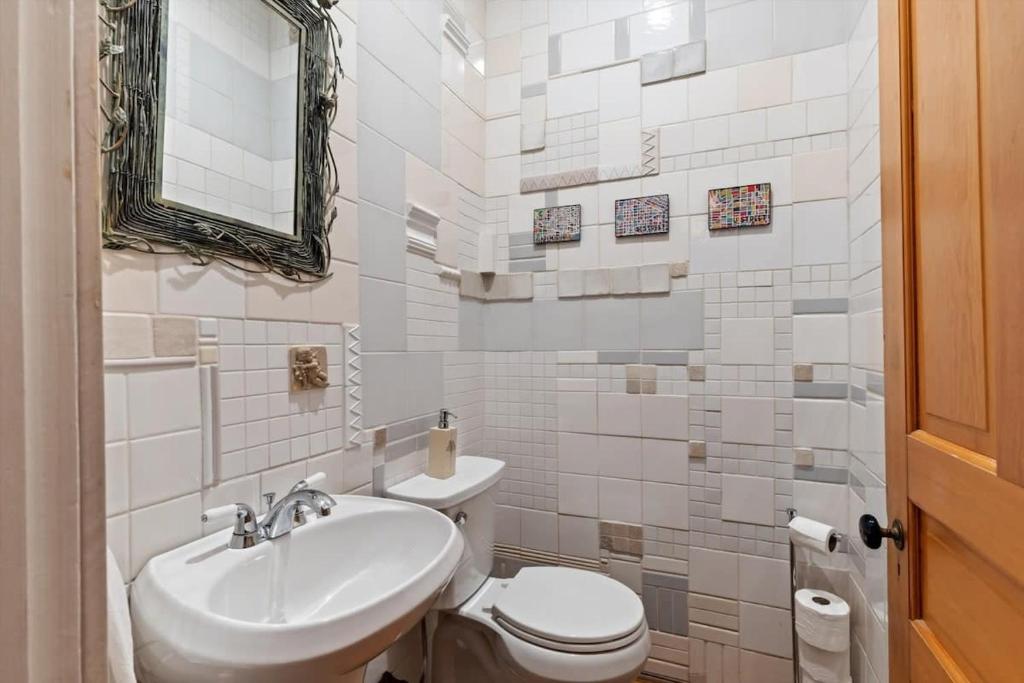 a white bathroom with a sink and a toilet at Historic Capital Hill Home and Carriage House in Washington, D.C.