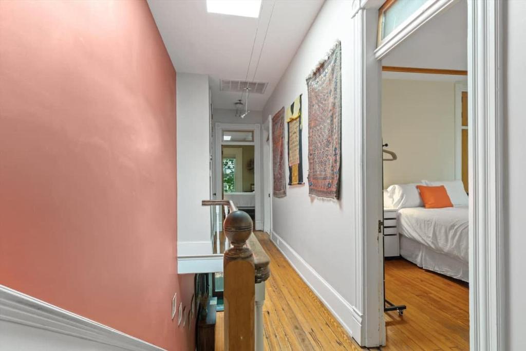 a hallway with a room with a bed and a window at Historic Capital Hill Home and Carriage House in Washington, D.C.