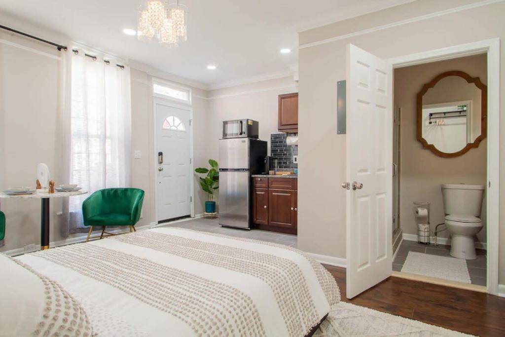 a white bedroom with a bed and a kitchen at Little Penthouse in Little Italy Near Inner Harbor Studio in Baltimore