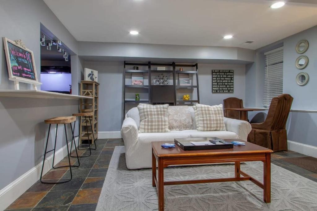 a living room with a white couch and a table at Delightful 1-BR Accommodations Nearby METRO in Washington, D.C.